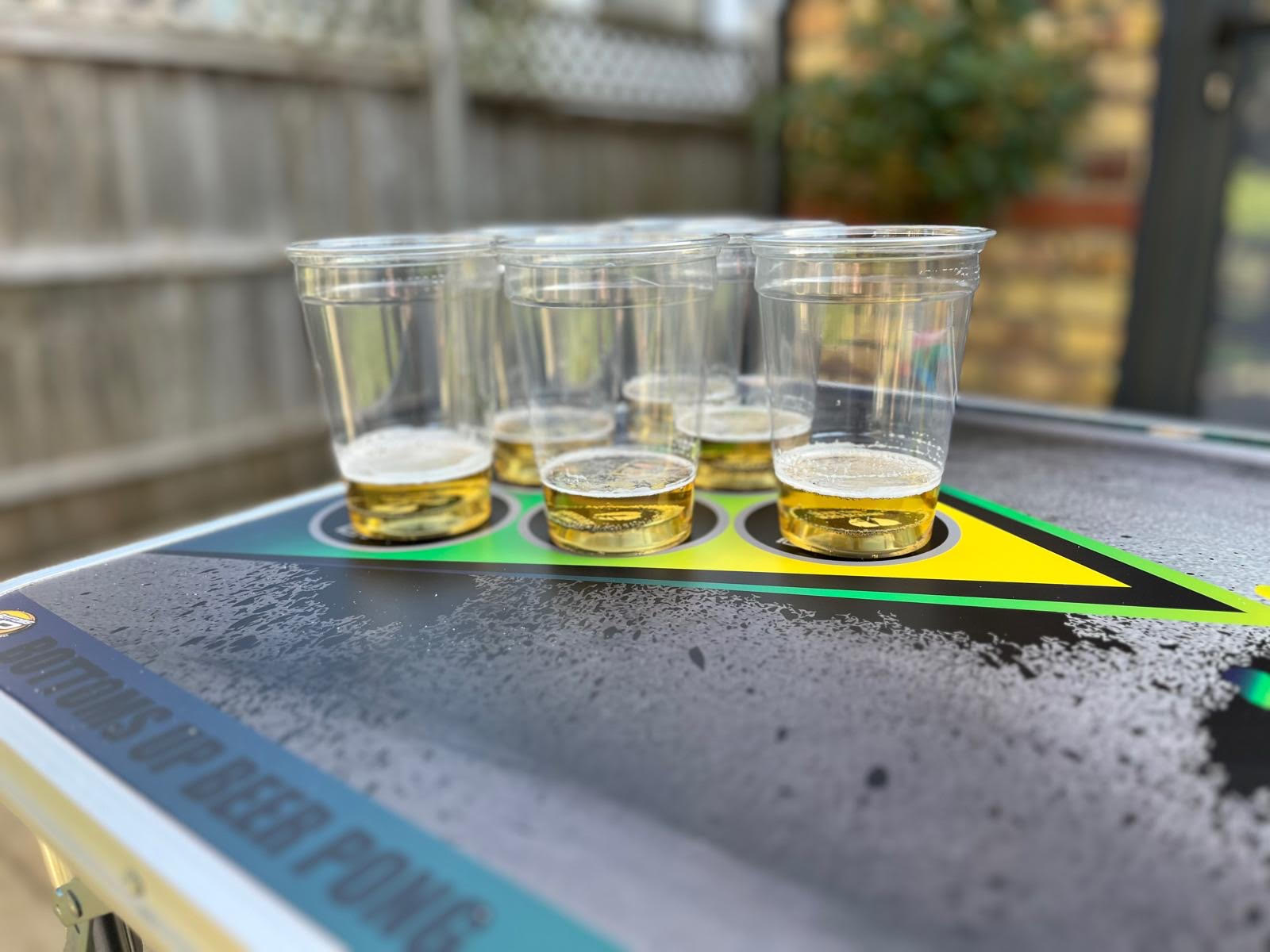 Beer pong cups on a Bottoms Up branded King Pong table